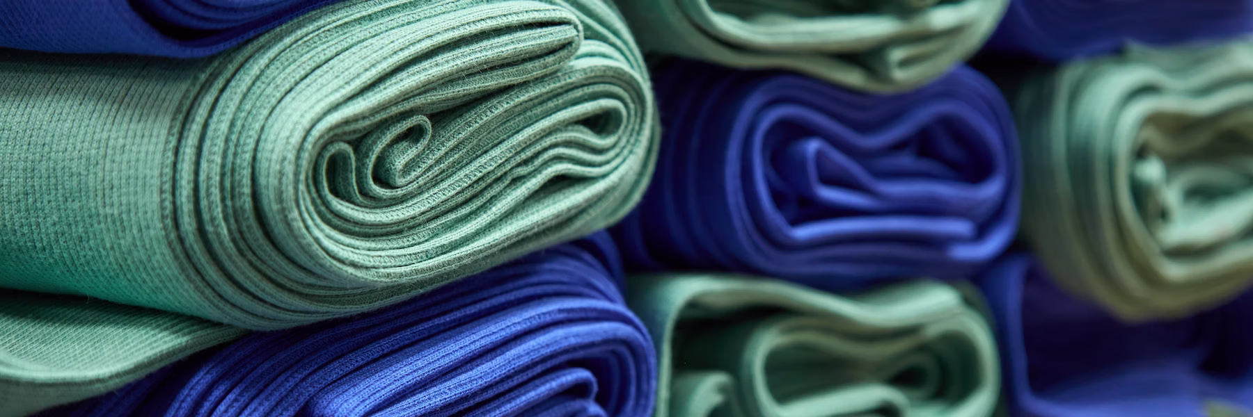 Stacked folded fabric rolls